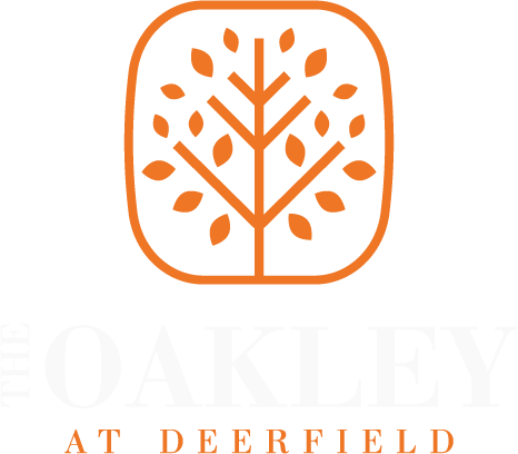 A logo with a tree and the words Oakley at Deerfield.